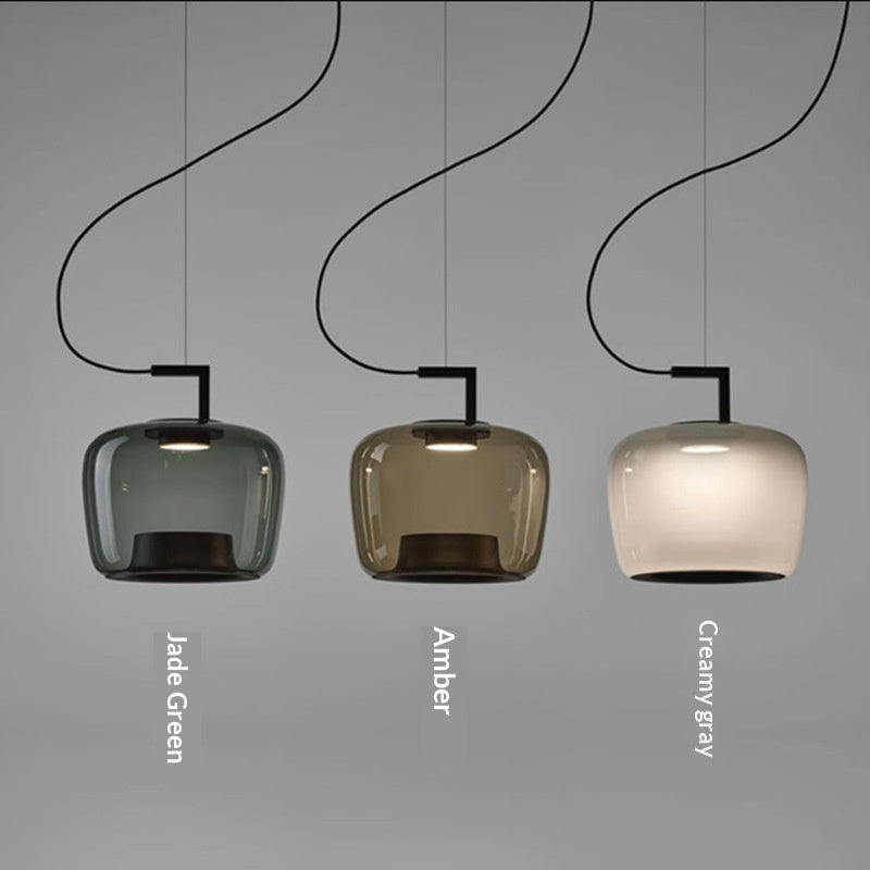 Underside view of the glass shade with the bulb glowing warm inside
