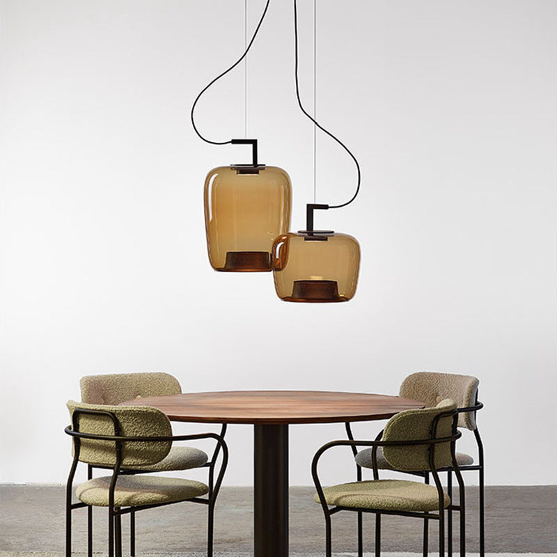 Pendant lamp lit in a dim minimalist interior corner beside a linen chair