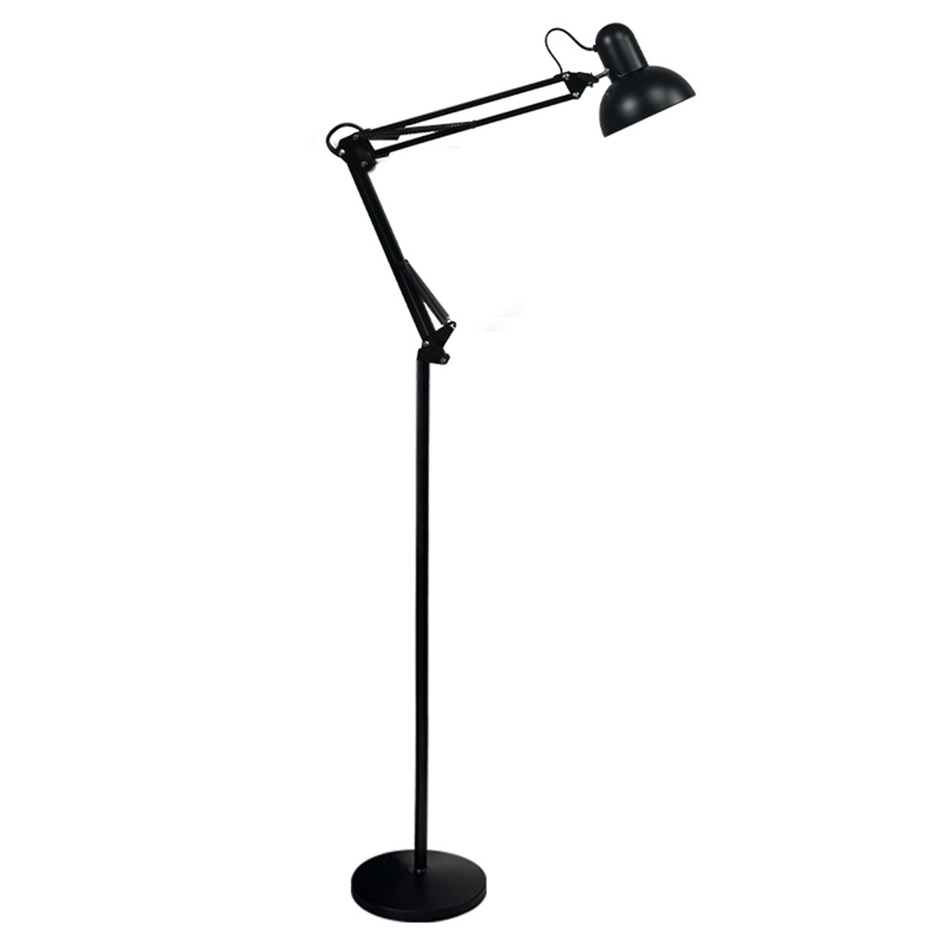 Floor lamp lit low beside a crib and nightstand at night